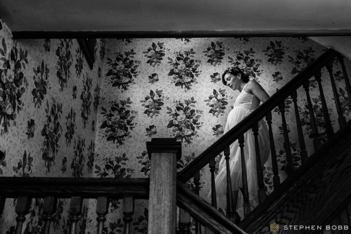 Bride descending stairs for at-home wedding